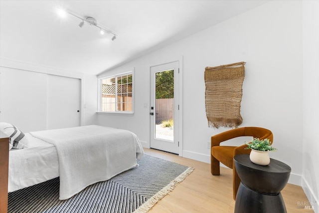 462 Hickory Ln, San Rafael, CA 94903 - bedroom with track lighting, access to outside, light wood-style floors, vaulted ceiling, and baseboards