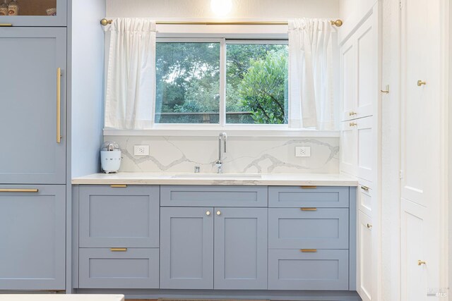 439 4th St E, Sonoma, CA 95476 - kitchen with a sink, decorative backsplash, light stone counters, and gray cabinets