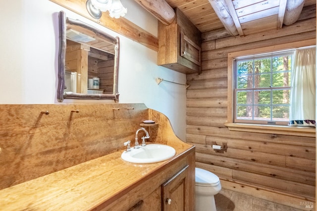 9547 Grassland Ct, Shingletown, CA 96088 - full bathroom with wood ceiling with exposed beams, vanity, toilet, and rustic walls
