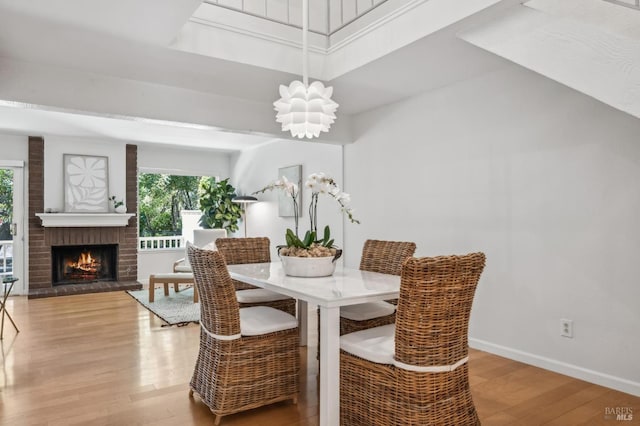 9 California Condor Way, Novato, CA 94949 - dining room featuring plenty of natural light, wood finished floors, a brick fireplace, baseboards, and a high ceiling