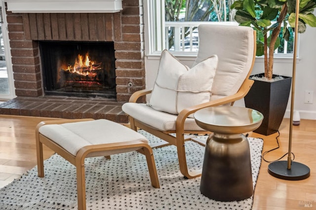 9 California Condor Way, Novato, CA 94949 - living area with a brick fireplace, wood finished floors, and baseboards