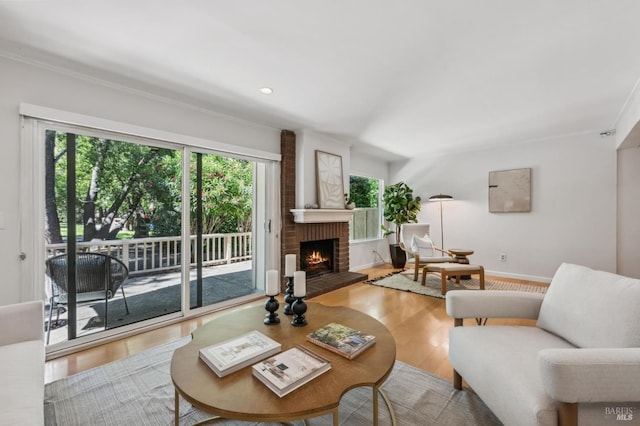 9 California Condor Way, Novato, CA 94949 - living area featuring wood finished floors, a brick fireplace, ornamental molding, and baseboards