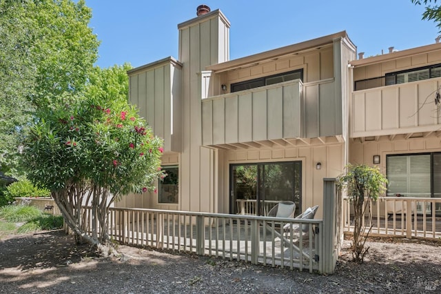 9 California Condor Way, Novato, CA 94949 - rear view of property featuring board and batten siding, a balcony, and a chimney