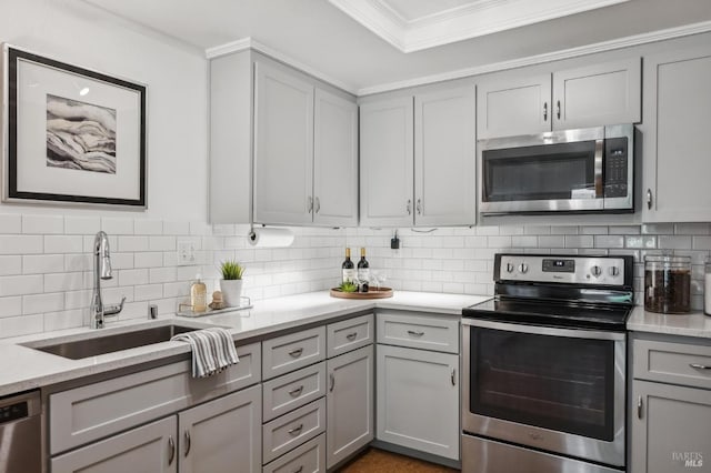 9 California Condor Way, Novato, CA 94949 - kitchen featuring stainless steel appliances, gray cabinets, a sink, decorative backsplash, and crown molding