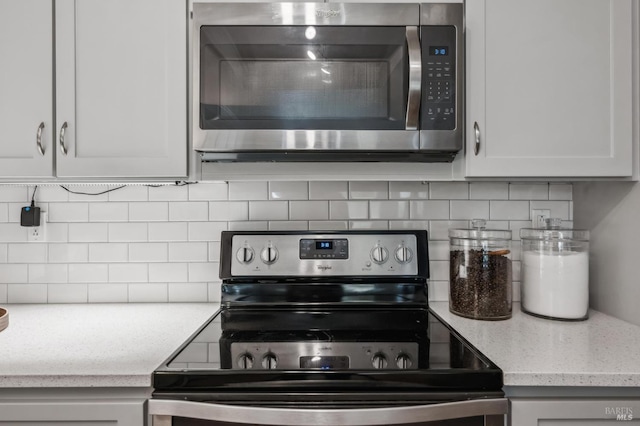 9 California Condor Way, Novato, CA 94949 - kitchen featuring stainless steel appliances, tasteful backsplash, white cabinets, and light stone countertops