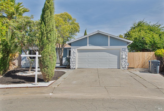 50 Montego Ct, Suisun City, CA 94585 - view of front of house featuring stone siding, driveway, a garage, and stucco siding