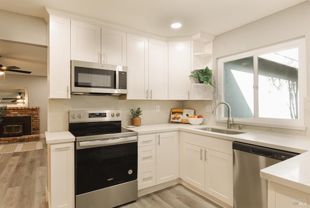 50 Montego Ct, Suisun City, CA 94585 - kitchen featuring appliances with stainless steel finishes, ceiling fan, open shelves, white cabinets, and light wood-type flooring