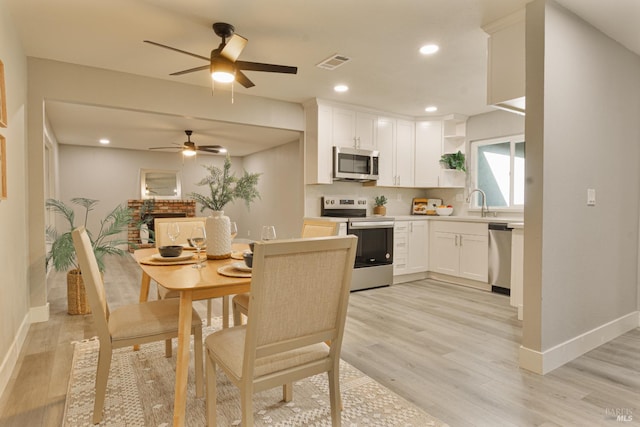 50 Montego Ct, Suisun City, CA 94585 - dining room featuring light wood-type flooring, ceiling fan, and recessed lighting