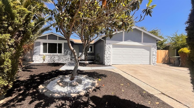 50 Montego Ct, Suisun City, CA 94585 - view of front of home with stone siding, stucco siding, concrete driveway, and a garage