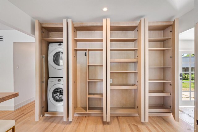 3641 Evergreen Ct, Napa, CA 94558 - laundry room with stacked washer / drying machine, light wood-style floors, and baseboards