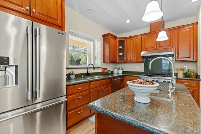 14600 Jomark Ln, Occidental, CA 95465 - kitchen featuring stainless steel appliances, a sink, under cabinet range hood, dark stone counters, and pendant lighting