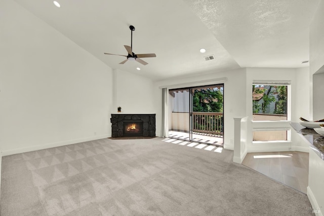21100 Gary Dr Unit 215, Hayward, CA 94546 - unfurnished living room with lofted ceiling, carpet floors, baseboards, ceiling fan, and a stone fireplace
