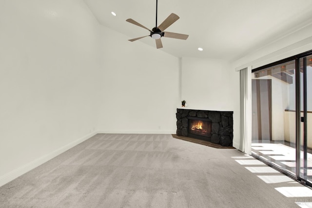 21100 Gary Dr Unit 215, Hayward, CA 94546 - unfurnished living room featuring carpet, vaulted ceiling, a stone fireplace, a ceiling fan, and baseboards