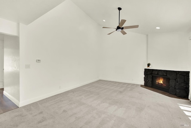 21100 Gary Dr Unit 215, Hayward, CA 94546 - unfurnished living room featuring lofted ceiling, carpet flooring, ceiling fan, a stone fireplace, and baseboards