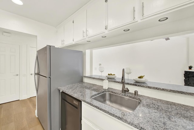 21100 Gary Dr Unit 215, Hayward, CA 94546 - kitchen with a sink, appliances with stainless steel finishes, white cabinetry, light wood-style flooring, and light stone counters
