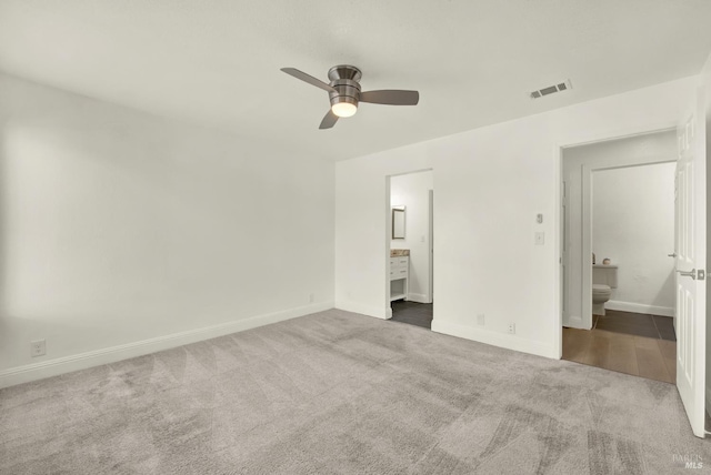 21100 Gary Dr Unit 215, Hayward, CA 94546 - unfurnished bedroom with connected bathroom, carpet flooring, baseboards, and ceiling fan