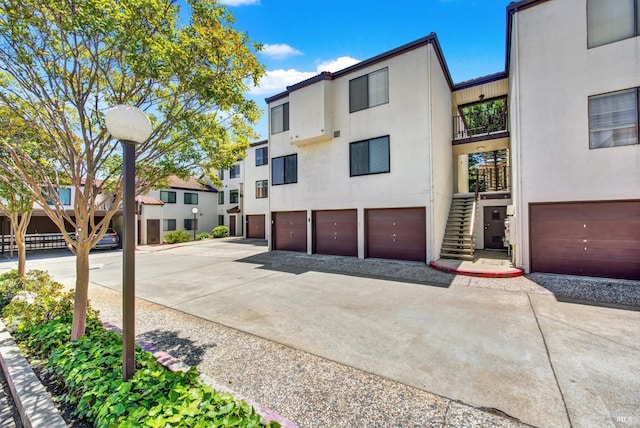 21100 Gary Dr Unit 215, Hayward, CA 94546 - view of building exterior featuring driveway, stairs, and an attached garage