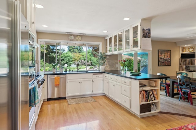 291 Maple Ave, Kenwood, CA 95452 - kitchen featuring appliances with stainless steel finishes, dark countertops, a sink, white cabinets, and light wood-style flooring