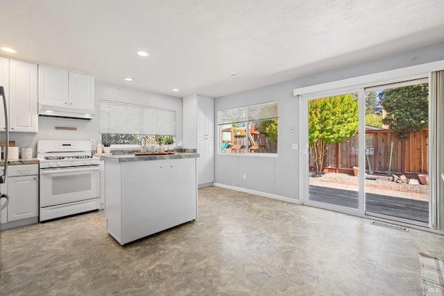 6576 Jade Ct, Rohnert Park, CA 94928 - kitchen with white gas range oven, under cabinet range hood, healthy amount of natural light, white cabinetry, and recessed lighting