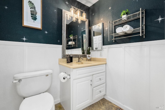6576 Jade Ct, Rohnert Park, CA 94928 - bathroom with wainscoting, vanity, toilet, and a decorative wall