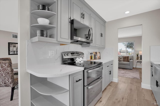 323 Larkin Ct, Benicia, CA 94510 - kitchen with open shelves, stainless steel appliances, gray cabinetry, light wood finished floors, and recessed lighting