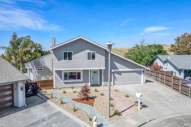 323 Larkin Ct, Benicia, CA 94510 - view of front of home featuring concrete driveway, a chimney, stucco siding, and a garage