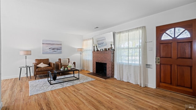 701 Nevada St, Fairfield, CA 94533 - living room with light wood finished floors, a brick fireplace, and baseboards