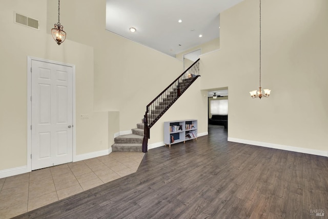 2467 Flatley Cir, Fairfield, CA 94533 - foyer with a high ceiling, stairway, wood finished floors, a chandelier, and baseboards