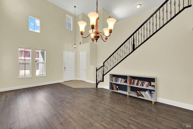 2467 Flatley Cir, Fairfield, CA 94533 - foyer featuring a chandelier, wood finished floors, a high ceiling, stairs, and baseboards