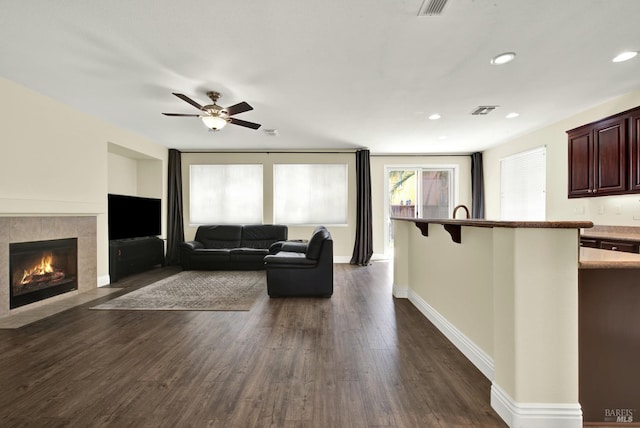 2467 Flatley Cir, Fairfield, CA 94533 - living area featuring a fireplace, dark wood-style flooring, a ceiling fan, baseboards, and recessed lighting