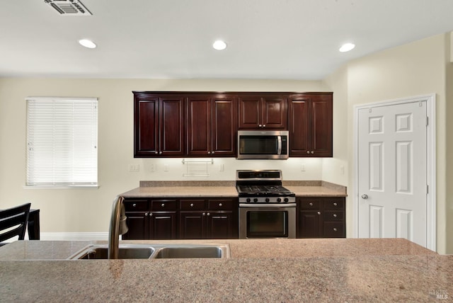 2467 Flatley Cir, Fairfield, CA 94533 - kitchen featuring appliances with stainless steel finishes, dark brown cabinetry, a sink, recessed lighting, and light countertops