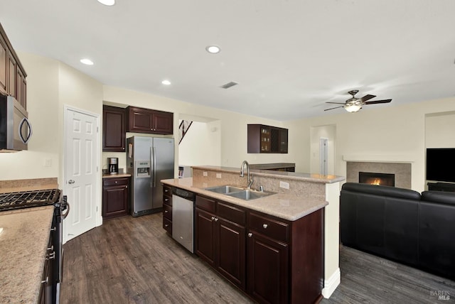 2467 Flatley Cir, Fairfield, CA 94533 - kitchen featuring appliances with stainless steel finishes, a sink, ceiling fan, a center island with sink, and dark wood-style flooring