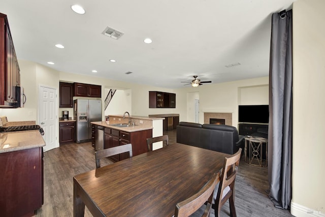 2467 Flatley Cir, Fairfield, CA 94533 - dining space with ceiling fan, dark wood-style floors, a lit fireplace, and recessed lighting