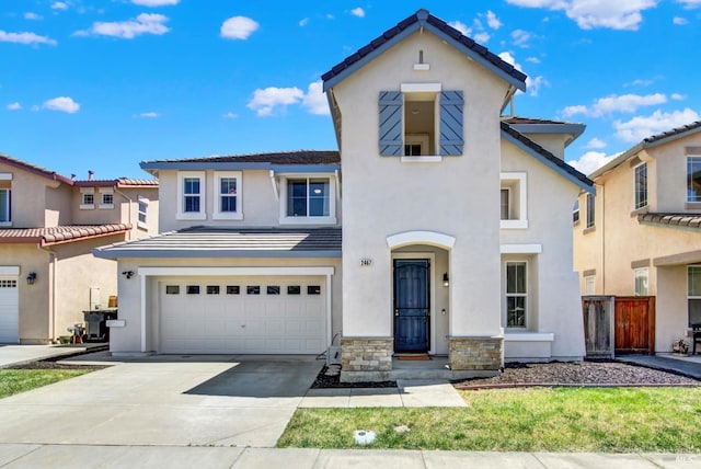 2467 Flatley Cir, Fairfield, CA 94533 - view of front facade with a garage, driveway, stucco siding, a tile roof, and stone siding