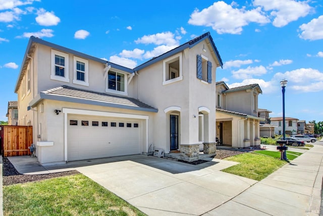 2467 Flatley Cir, Fairfield, CA 94533 - view of front of home featuring a garage, concrete driveway, stucco siding, and a tiled roof