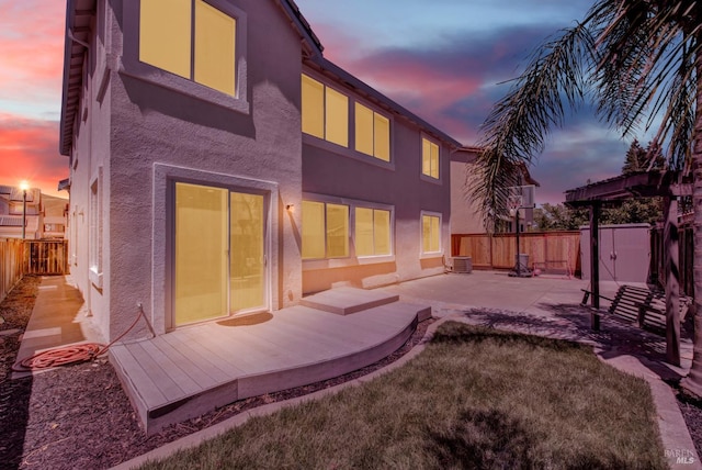 2467 Flatley Cir, Fairfield, CA 94533 - back of house at dusk featuring stucco siding and a patio