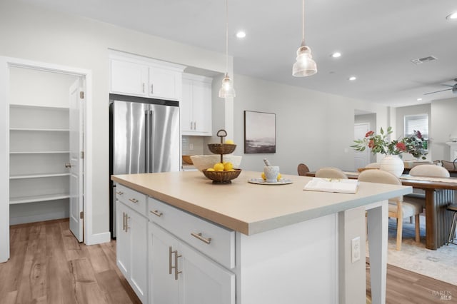 2579 Estery Ln, Santa Rosa, CA 95403 - kitchen with light wood-style flooring, a center island, white cabinets, light countertops, and recessed lighting