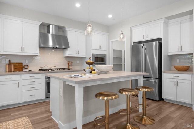 2579 Estery Ln, Santa Rosa, CA 95403 - kitchen with stainless steel appliances, wall chimney exhaust hood, light countertops, white cabinetry, and recessed lighting