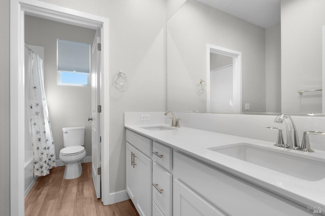 2579 Estery Ln, Santa Rosa, CA 95403 - bathroom with toilet, double vanity, wood finished floors, shower / bath combination with curtain, and baseboards