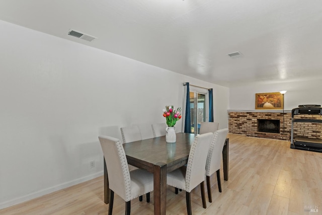 2235 Nottingham Dr, Fairfield, CA 94534 - dining space featuring light wood finished floors, a fireplace, and baseboards