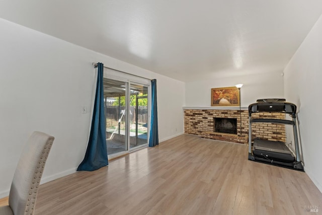 2235 Nottingham Dr, Fairfield, CA 94534 - exercise room with light wood-style floors, a brick fireplace, and baseboards