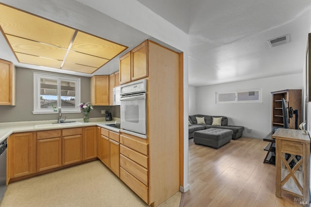 2235 Nottingham Dr, Fairfield, CA 94534 - kitchen with a sink, white appliances, light countertops, open floor plan, and light wood-type flooring