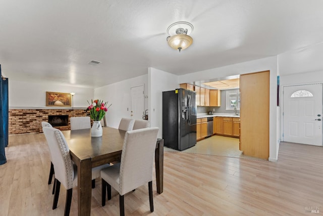 2235 Nottingham Dr, Fairfield, CA 94534 - dining space with light wood finished floors and a brick fireplace