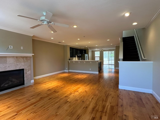 764 Mcclelland Dr, Windsor, CA 95492 - unfurnished living room featuring a tile fireplace, crown molding, hardwood / wood-style flooring, ceiling fan, and recessed lighting