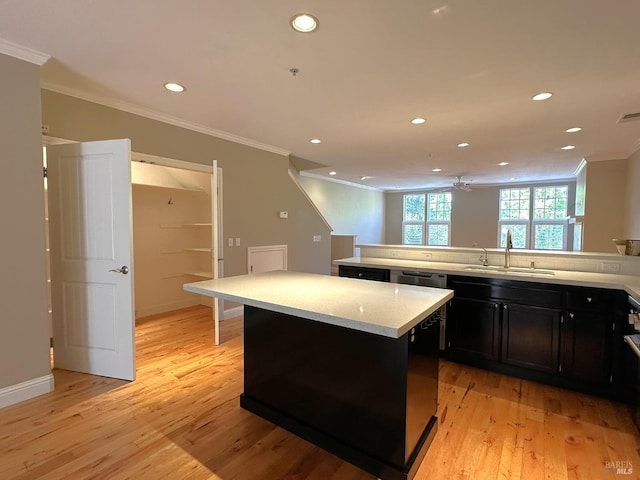 764 Mcclelland Dr, Windsor, CA 95492 - kitchen featuring ornamental molding, recessed lighting, light wood-style floors, a center island, and dark cabinets