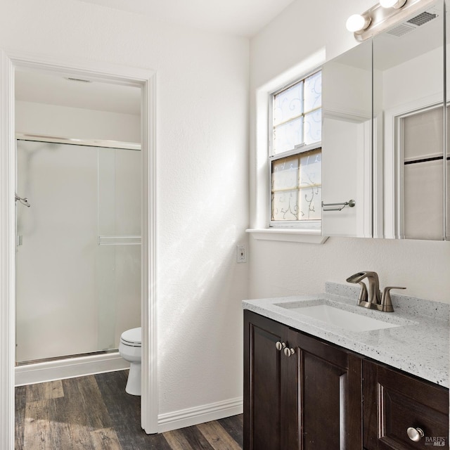 1039 Aston Cir, Santa Rosa, CA 95404 - bathroom with toilet, vanity, wood finished floors, a shower stall, and baseboards
