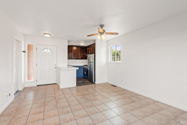 1039 Aston Cir, Santa Rosa, CA 95404 - kitchen with appliances with stainless steel finishes, light countertops, a ceiling fan, dark brown cabinets, and light tile patterned flooring