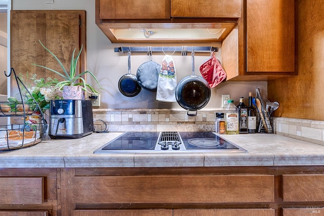 5851 Vine Hill Rd, Sebastopol, CA 95472 - kitchen view of brown cabinets, black electric stovetop, and bar