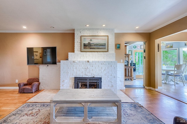 5851 Vine Hill Rd, Sebastopol, CA 95472 - living area with crown molding, recessed lighting, wood finished floors, baseboards, and a brick fireplace