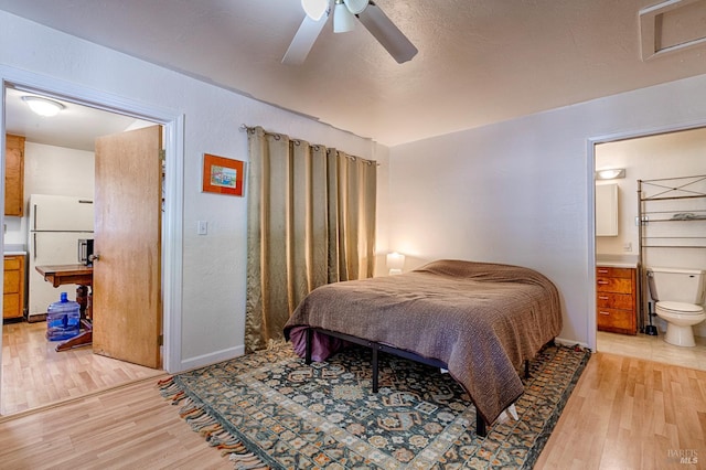 5851 Vine Hill Rd, Sebastopol, CA 95472 - bedroom featuring freestanding refrigerator, light wood-style floors, connected bathroom, baseboards, and ceiling fan